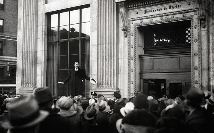 John Poole, president of the Federal American National Bank in Washington, D.C., stands on a narrow ledge outside the building and declares to the crowd that the institution was sound, February 5, 1931.