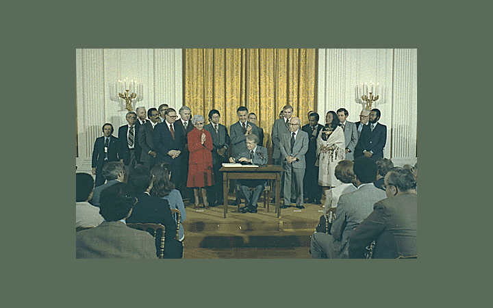 Jimmy Carter signs the Humphrey-Hawkins Bill, October 27, 1978 (via Jimmy Carter Library and National Archives and Records Administration.)