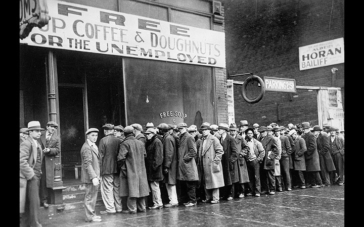 <p>Unemployed men queued outside a depression soup kitchen opened in Chicago by Al Capone, 1931 (U.S. Information Agency via <a href="https://commons.wikimedia.org/wiki/File:Unemployed_men_queued_outside_a_depression_soup_kitchen_opened_in_Chicago_by_Al_Capone,_02-1931_-_NARA_-_541927.jpg">Wikimedia Commons</a>)</p>