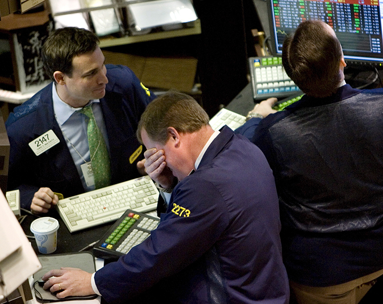 Traders await news of the Federal Reserve's response to the mortgage crisis at the New York Stock Exchange.