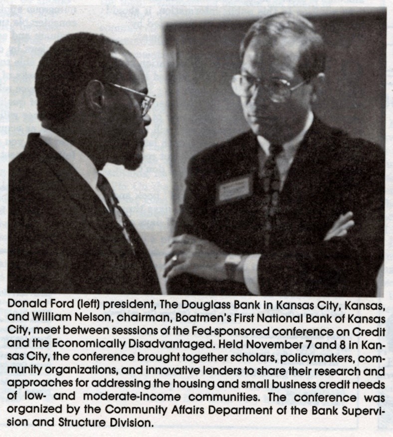 A photo of two men in suits. The man on the left is Black and the man on the right is White. The caption reads 'Donald Ford (left) president, The Douglass Bank in Kansas City, Kansas, and William Nelson, chairman, Boatmen's First National Bank of Kansas City, meet between sessions of the Fed-sponsored Conference on Credit and the Economically Disadvantaged. Held November 7 and 8 in Kansas City, the conference brought together scholars, policymakers, community organizations, and innovative lenders to share their research and approaches for addressing the housing and small business credit needs of low- and moderate-income communities. The conference was organized by the Community Affairs Department of the Bank Supervision and Structure Division.'