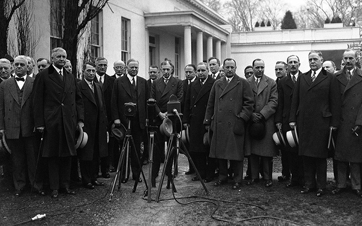 President Herbert Hoover and reconstruction leaders meet in Washington on February 6, 1932, to discuss the president's contemplated campaign against national hoarding
