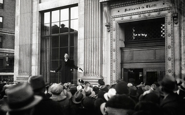 <p>John Poole, president of the Federal American National Bank in Washington, D.C., stands on a&nbsp;narrow ledge outside the building and declares to the crowd that the institution was sound, February 5, 1931.&nbsp;</p>