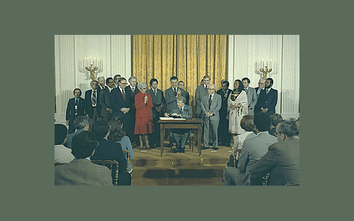 <p>Jimmy Carter signs the Humphrey-Hawkins Bill, October 27, 1978 (via Jimmy Carter Library and National Archives and Records Administration, <a href="https://catalog.archives.gov/id/1d82117">NAID 182117</a>)&nbsp;</p>