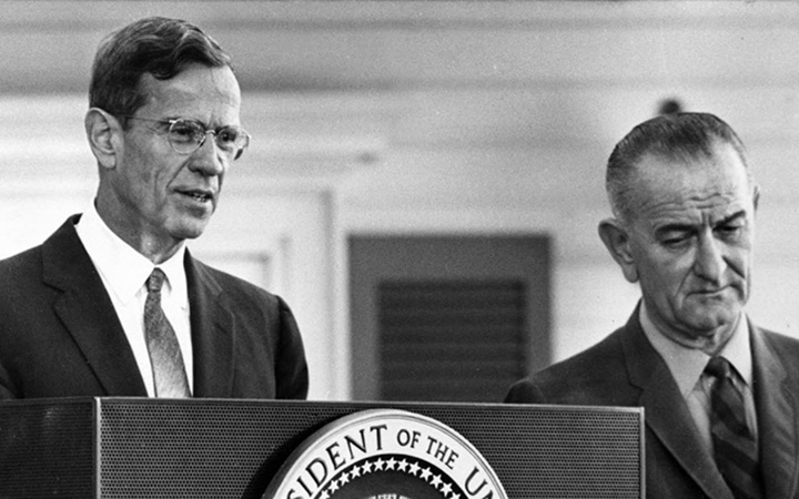 Federal Reserve Board Chairman William McChesney Martin, pictured beside President Lyndon Johnson, discusses the Board’s action on raising the discount rate at a December 1965 news conference.